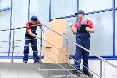 Movers carrying household furniture during a flat move in Nottinghill