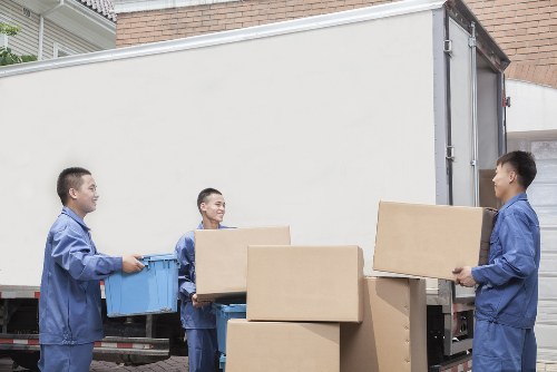Unpacking service arranging boxes in a bright Notting Hill property