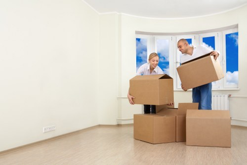Mover carrying furniture carefully through a property