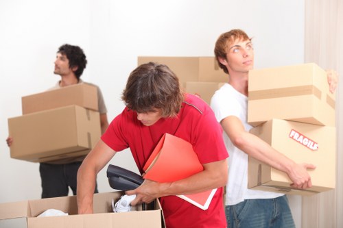 Professional movers carrying furniture during a Nottinghill relocation