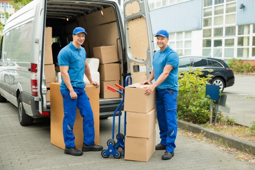 Moving team handling bulky furniture in Nottinghill