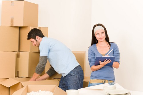 Team planning an office relocation in Nottinghill with labeled boxes and workspace layout